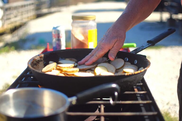 Fish frying in a skillet at camp