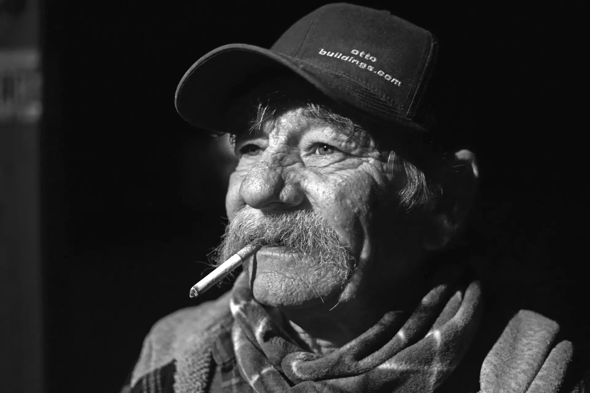 Black-and-white portrait of a cowboy with a cigarette